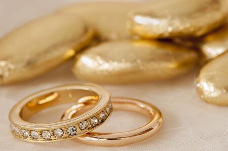 wedding favors and wedding ring on on colored backgroundの写真素材