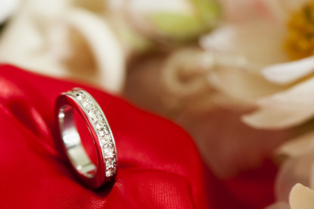  wedding rings on  a colorful fabric background