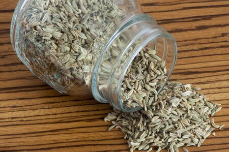 some fennel seeds on a wooden cutting board