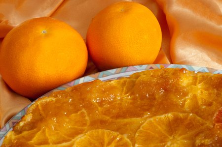 an orange homemade cake on fabric backgroundの写真素材