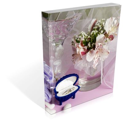 book of  wedding rings and wedding favors on a colorful backgroundの写真素材