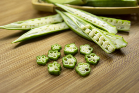 Okra on wood background. Overview. Green vegetables.
