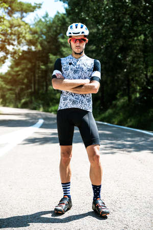 Portrait of young cyclist on the road. Sport concept