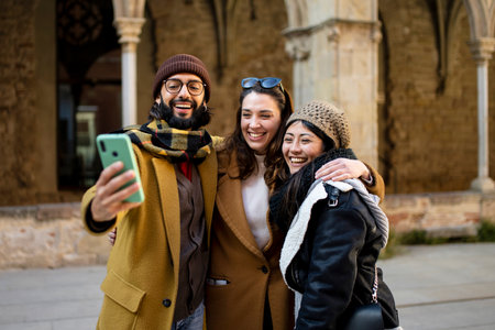 happy Multiracial group of friends making a selfie with phone in holidays, focus on the man - friendship, happiness and joyful conceptの写真素材
