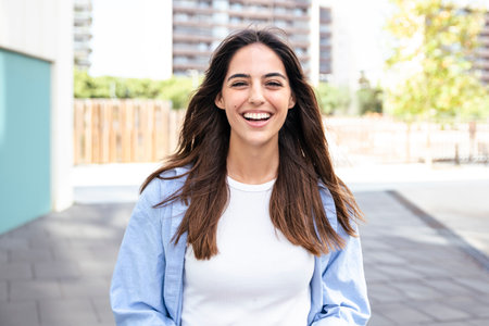 Young beautiful woman smiling and looking at camera in the city - Female, hapiness and joyful conceptの写真素材