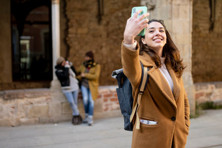 happy beautiful young woman taking selfie in the old city - holidays conceptの写真素材