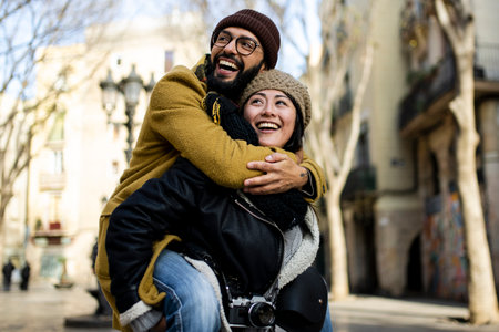 Couple of tourists having fun walking on city street at holiday - Happy friends laughing together on vacation - People and holidays conceptの写真素材