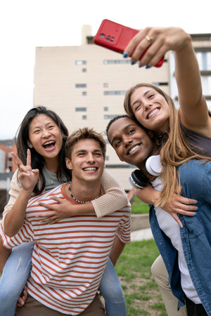 Multicultural joyful group of friends taking a selfie smiling .Diverse young people having fun and...