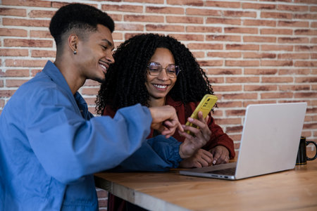 Happy diverse couple buying online investments and financial real estate at home. Husband and wife...