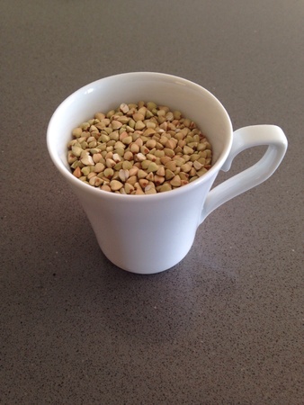 A white cup of buckwheat on a marble backgroundの素材