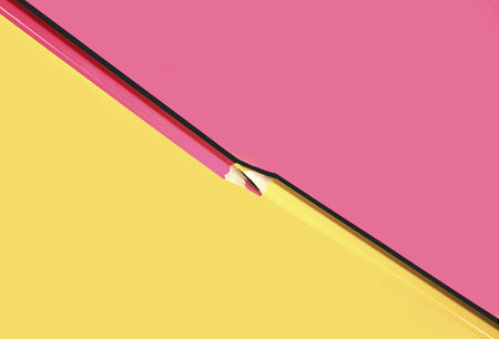 Flat lay pencils on a two-tone background in a minimalist artistic style.の写真素材
