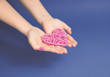 Heart on women's hands, giving love kind and support