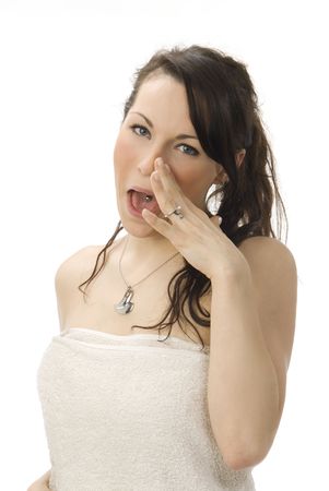 young and cute brunette dressing a beige towel in white backgroundの写真素材