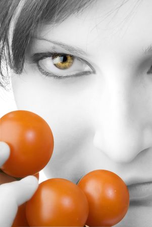 nice portrait of a girl with tomatoes and beautiful  attractive fair eyesの写真素材