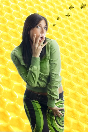 pretty girl with colored dress and bees coming の写真素材