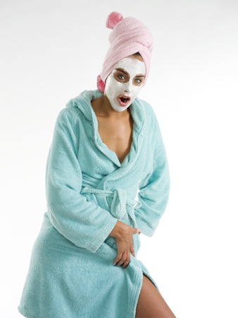 cute and nice girl with face cream mask posing and making faceの写真素材
