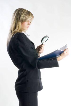 blond hostess in formal suit watching with a lens の写真素材