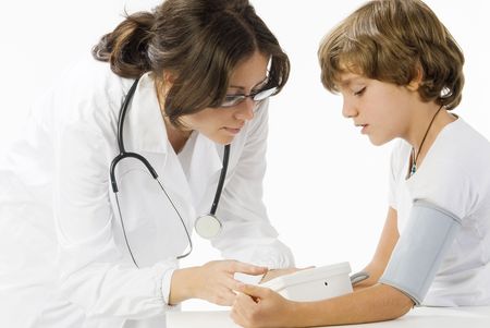 young and cute female doctor taking a blood pressure to a little boyの写真素材