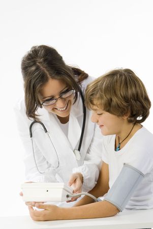 young and cute female doctor taking a blood pressure to a little boyの写真素材