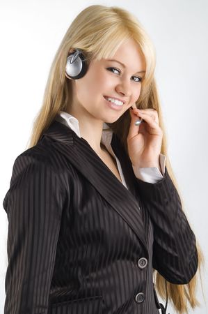 cute blond hostess chatting with earphone and smilingの写真素材