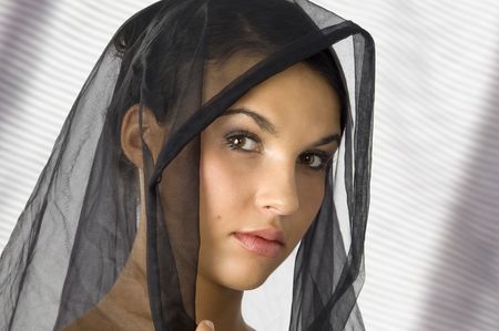 nice portrait of a young woman with a black veil on her head の写真素材