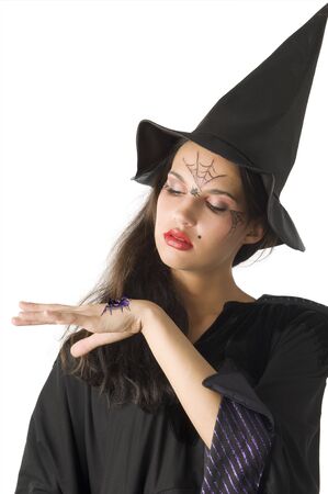pretty girl with witch hat and a spider on her handの写真素材