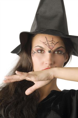 cute girl with witch hat and a spider web painted on faceの写真素材