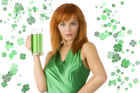redhead Irish Lass posing in green dress with glass of green beerの写真素材