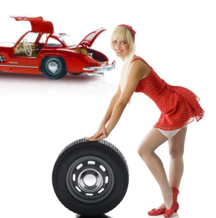 pretty blond pin up in red dress and white stockings taking poseの写真素材