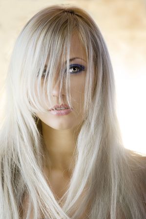 attractive blond girl with long hair in a fashion portraitの写真素材