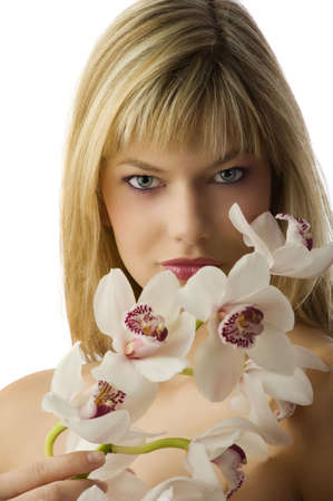 beautiful blond young girl with stunning eyes with some orchid の写真素材