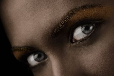 close up of stunning eyes in a dark desaturated shotの写真素材