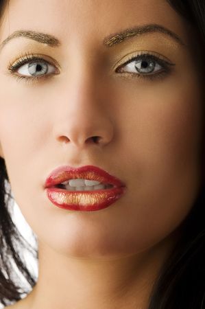 beauty shot of beautiful and young woman with golden creative make up
の写真素材