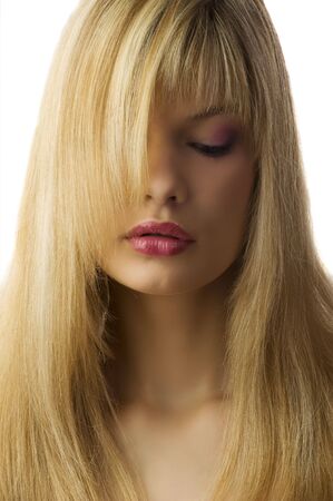 cute blond girl with color make up looking down with eyesの写真素材