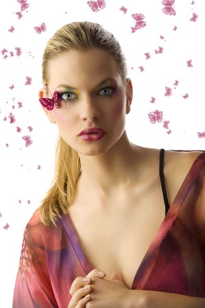 pretty blond woman  with creative makeup with butterfly on her face looking in camera surprisedの写真素材