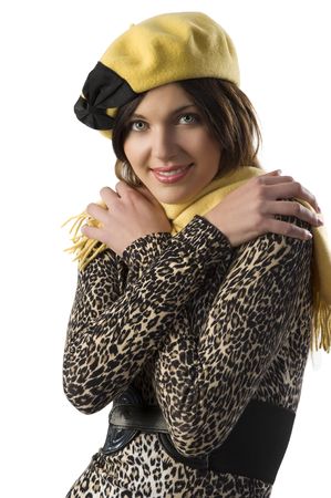 very cute girl in winter spotted dress with a nice yellow and black cap in a studio shotの写真素材