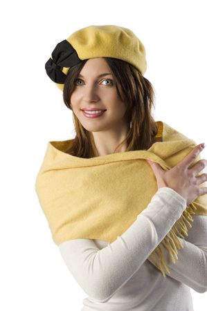 studio shot portrait of a sweet beauty with yellow cap and scarf smilingの写真素材