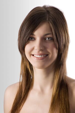 formal portrait of young pretty brunette with long hair looking in camera smilingの写真素材