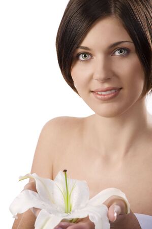 closeup beauty portrait of pretty young woman showing a big white lilyの写真素材