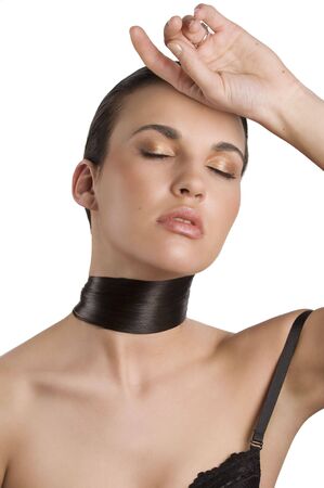 fashion portrait of a young brunette with her long black hair around her neck posing with closed eyes like an actressの写真素材