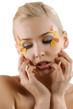pretty and young blond woman with colored creative make up on white backgroundの写真素材