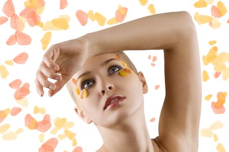 beautiful and young blond model posing wuth a creative colored make up on whiteの写真素材