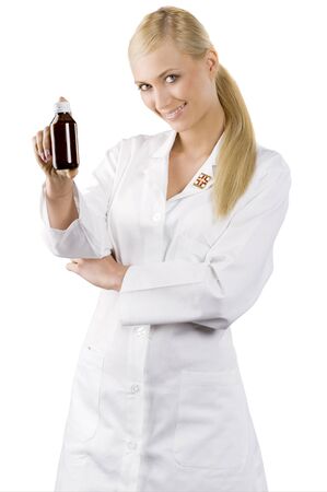 young blond woman in white gown as a nurse showing a madicine の写真素材