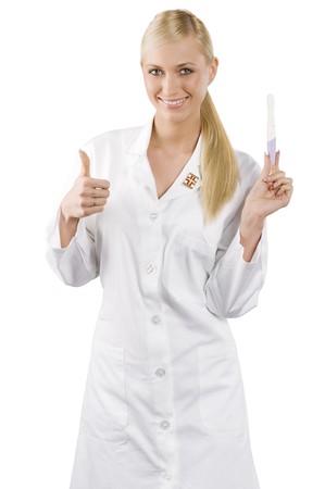 young blond woman as a nurse looking and showing a pregnant testの写真素材