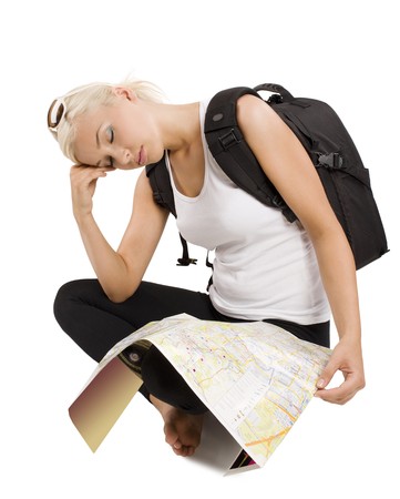 blond young tourist with map sitting down and sleeping の写真素材