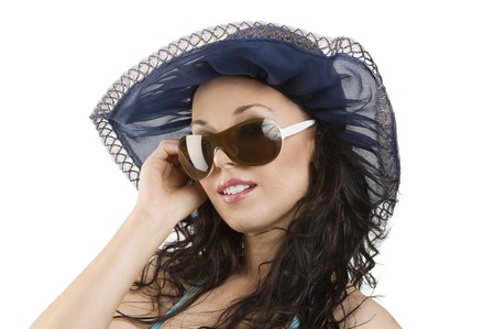 portrait of young woman with sunglasses and blue hatの写真素材