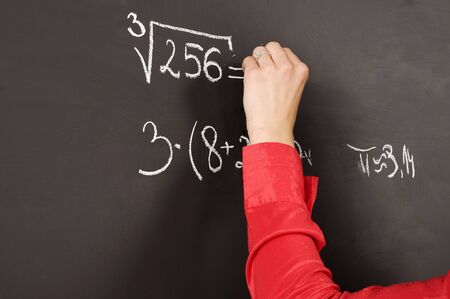 close up of a hand writing on a blackboardの写真素材