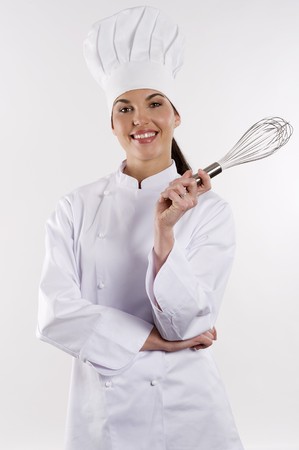 young graceful woman dressed as a cook with cap over white backgoundの写真素材