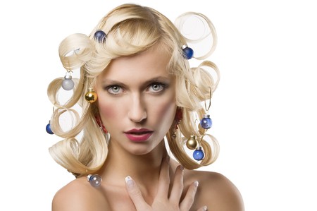 fashion shot of a blond girl with curly hair stylish like a christmas tree with little noel decorationの写真素材