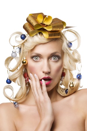 fashion shot of a blond girl with curly hair stylish like a christmas tree with little noel decorationの写真素材